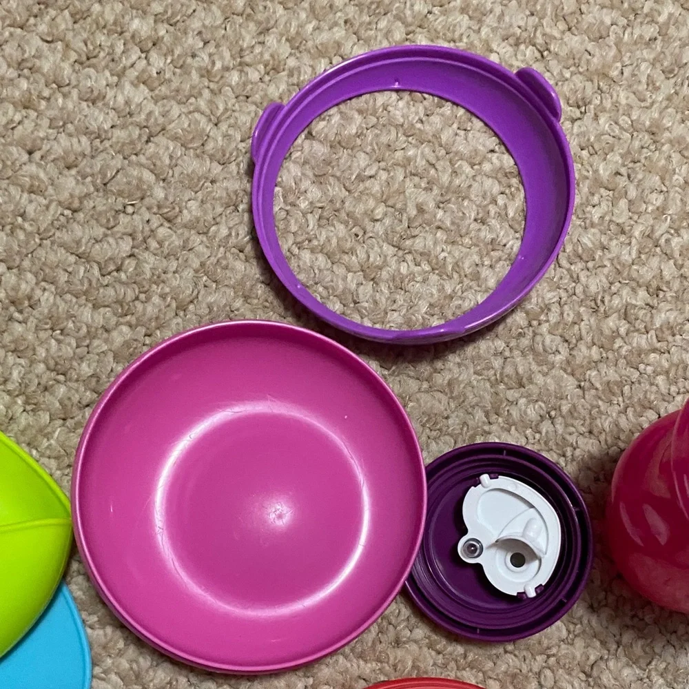 2 bibs, green & blue, 2 suction bowls, pink & purple, 1 tommie tippie sippie cup